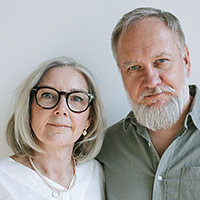 older couple - woman with glasses, man with grey beard