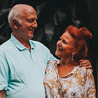 couple - woman with red hair smiling up at man